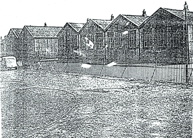 a greyscale image of the old tin-school